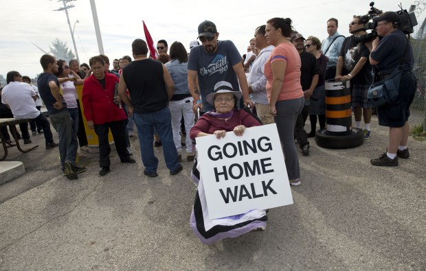 Barbara George, 83, is wheeled into the former military base at Camp Ipperwash as members of the Kettle and Stony Point First Nation celebrate the ratification of a deal that returns expropriated land to the band in Ipperwash, Ont. on Sunday September 20, 2015. Craig Glover/The London Free Press/Postmedia Network