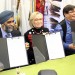 Minister of National Defence Harjit Sajjan, Minister of Indigenous and Northern Affairs Dr. Carolyn Bennett and Kettle and Stony Point Chief Tom Bressette show the signed final Ipperwash settlement